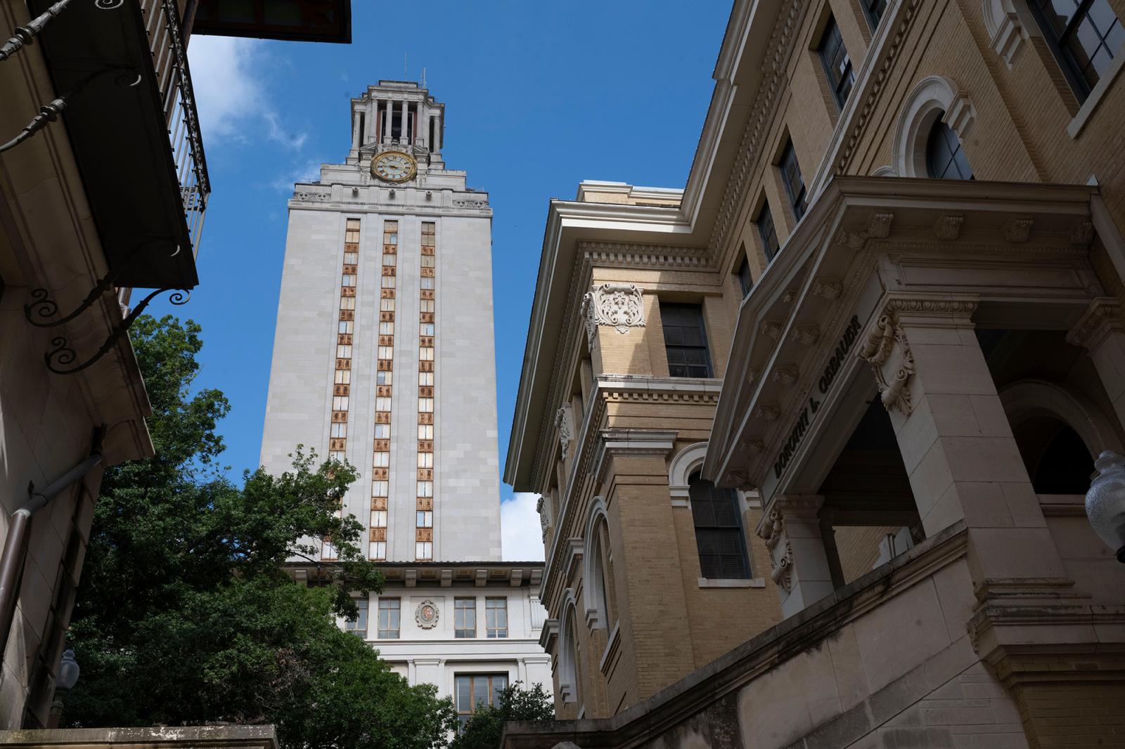 The UT Tower from a low angle between on-campus buildings