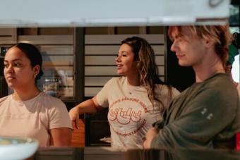 A first-gen student is pictured in a Horns Helping Horns t-shirt