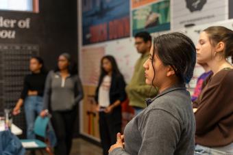 A group of students listen intently to a speaker