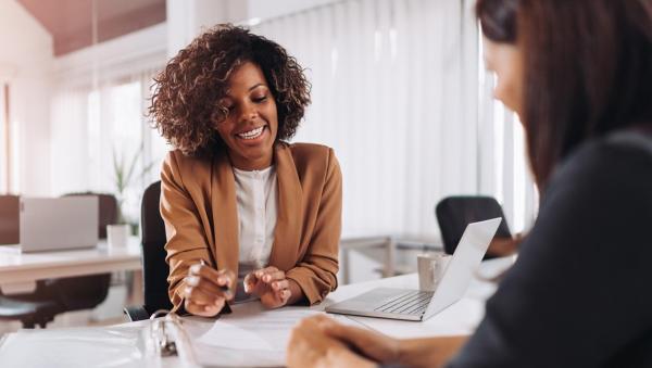 Two women sitting at a table talking
